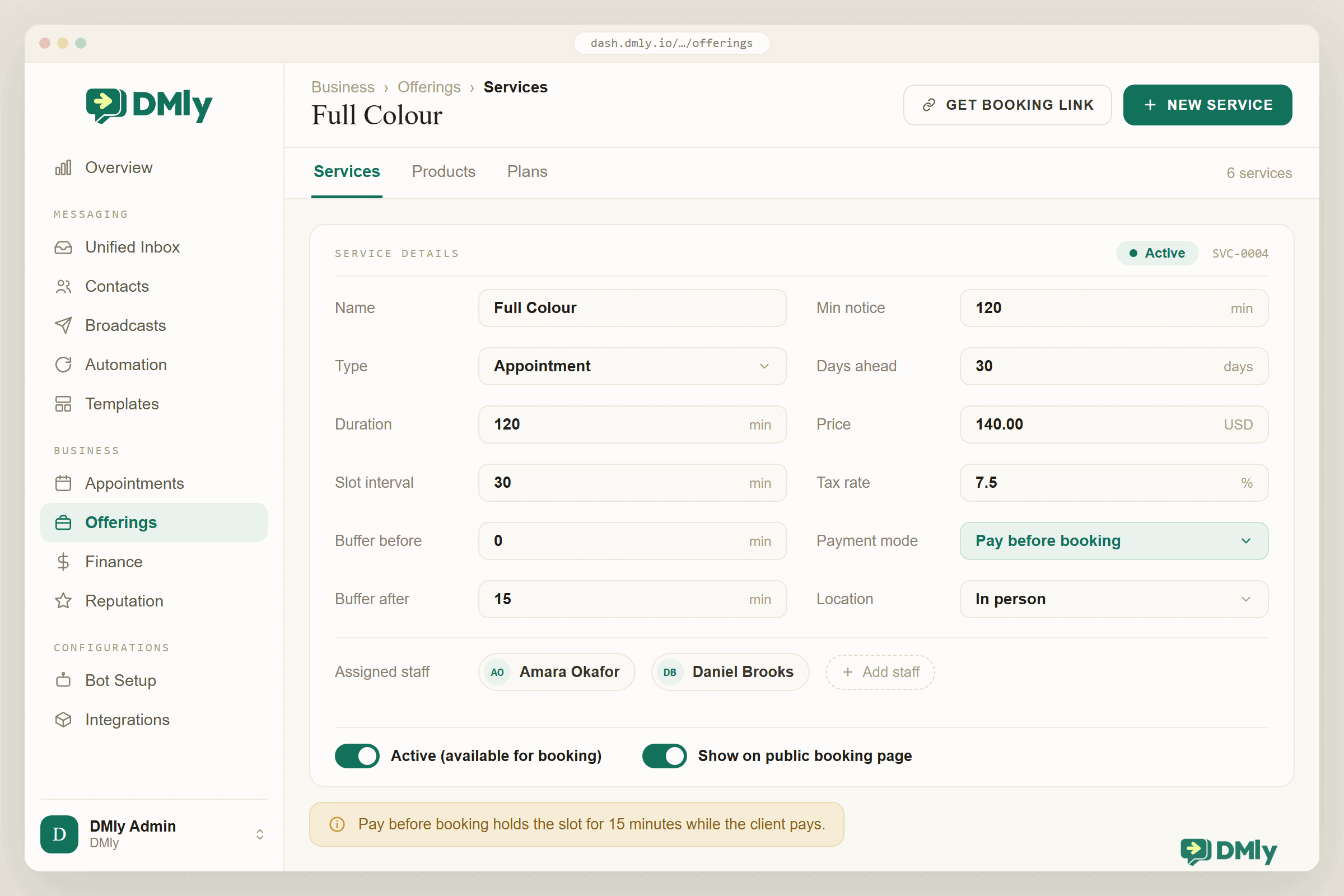 The DMly Offerings screen with the Services tab open and the Full Colour service in the editor, showing duration 120 min, slot interval 30 min, buffers, minimum notice, days ahead, price USD 140.00, tax 7.5% and payment mode set to Pay before booking, with Amara Okafor and Daniel Brooks assigned. Both switches, Active and Show on public booking page, are on, and an amber note says the slot is held for 15 minutes while the client pays.